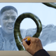 Roland Emmerich(‘s hand) illustrates how to make it look like Will Smith is about to deck an alien.